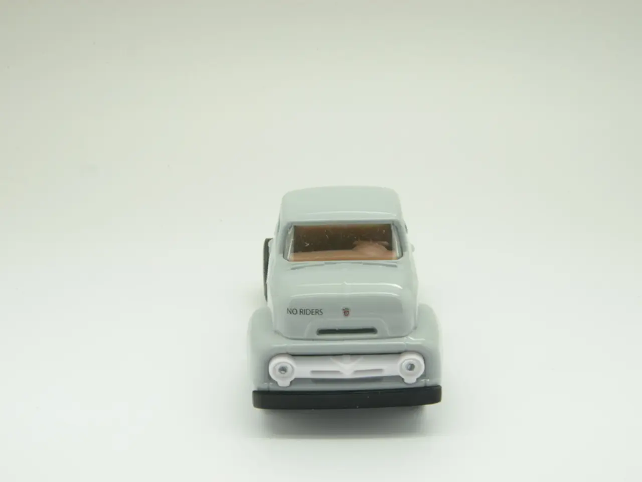 Here we can see a toy car. Background it is in white color.