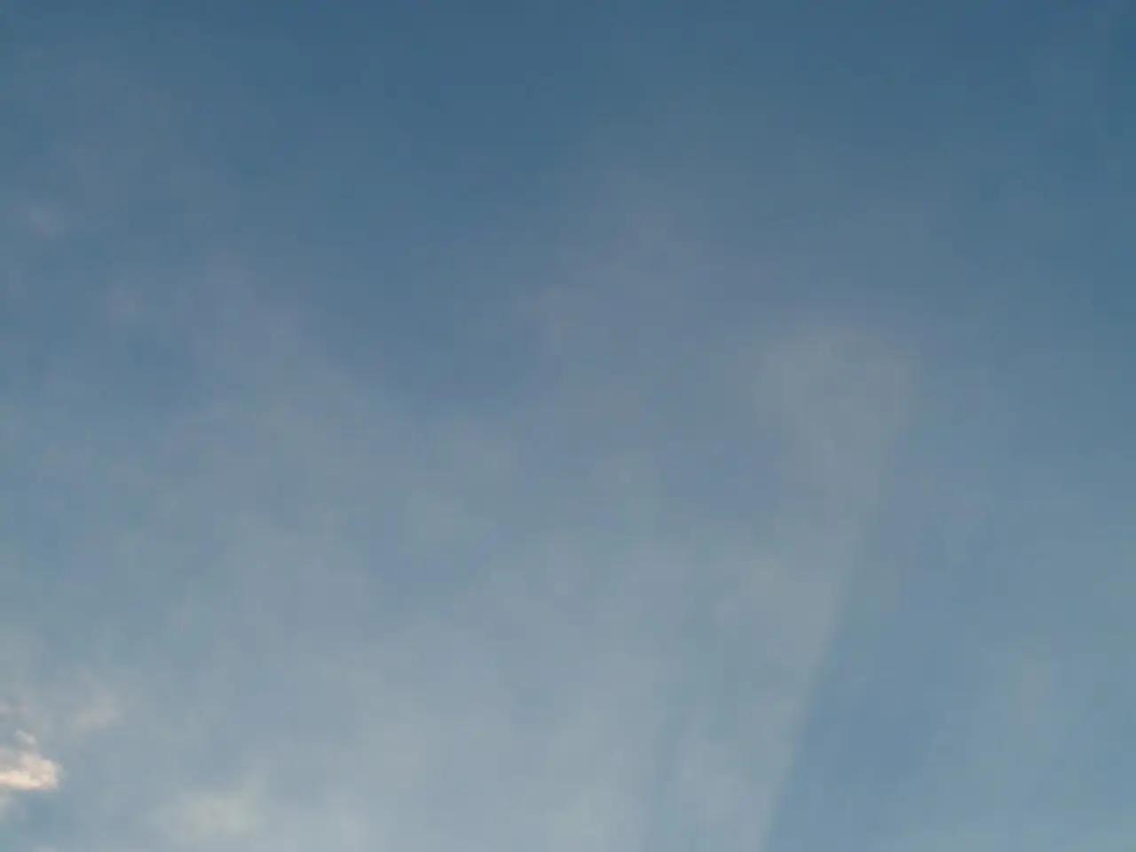 This picture is clicked outside the city. In the foreground we can see the trees, cables in the...