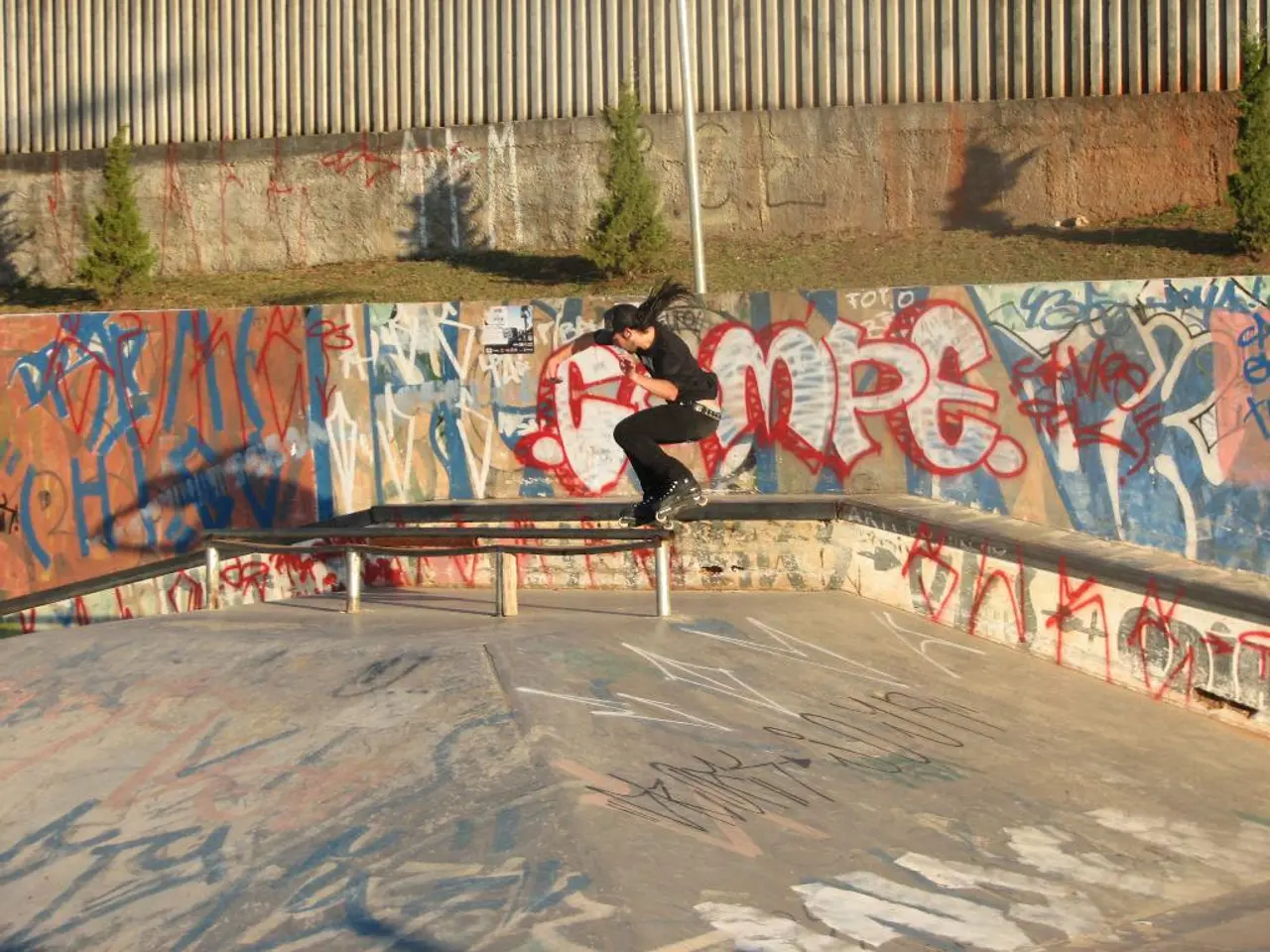Here we can see a person is skating on a skateboard on a platform and there are drawings on the...