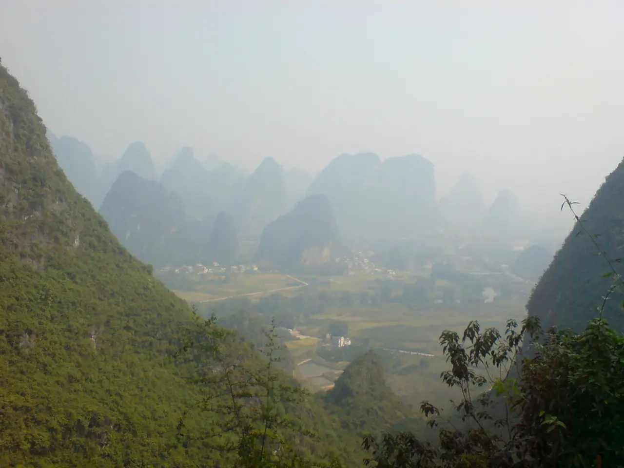 In this picture I can see there are few mountains and there are trees on the mountains and the sky...