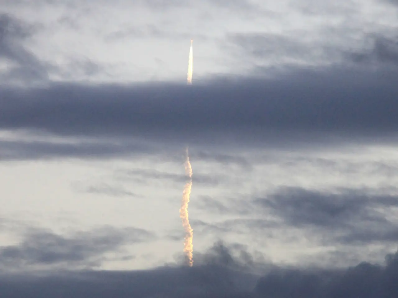 In the center of the picture there is a jet moving and there is smoke below its path. Sky is...