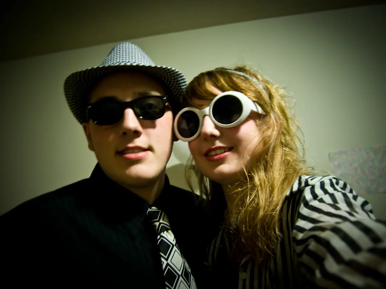 Here I can see a woman and a man smiling and giving pose for the picture. In the background, I can...