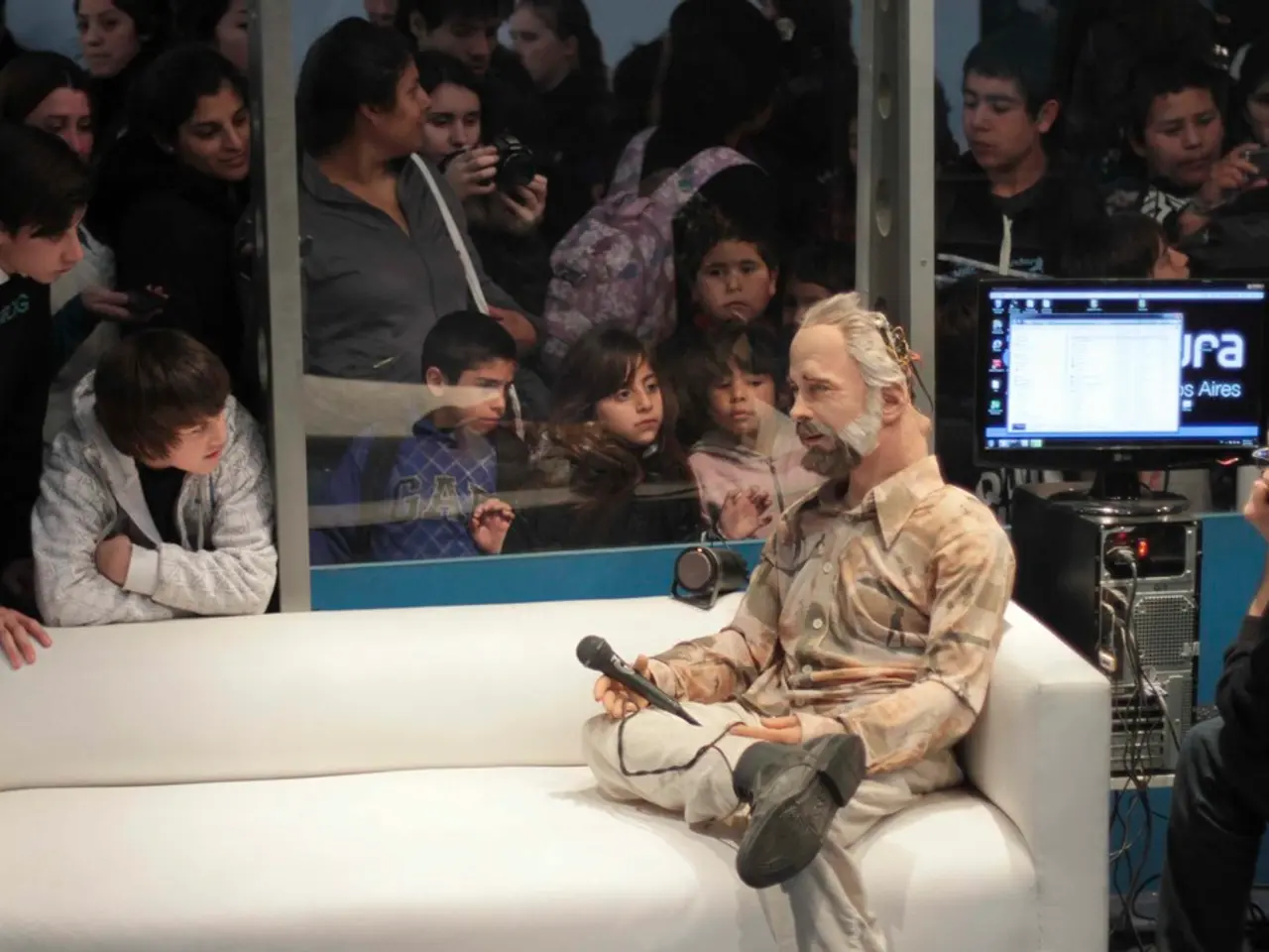 In this picture we can see a group of people standing and taking pictures of a puppet show were...