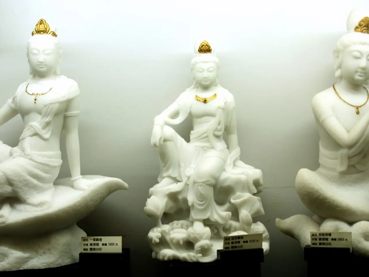 In the image we can see some idols. Behind the idols there is wall.