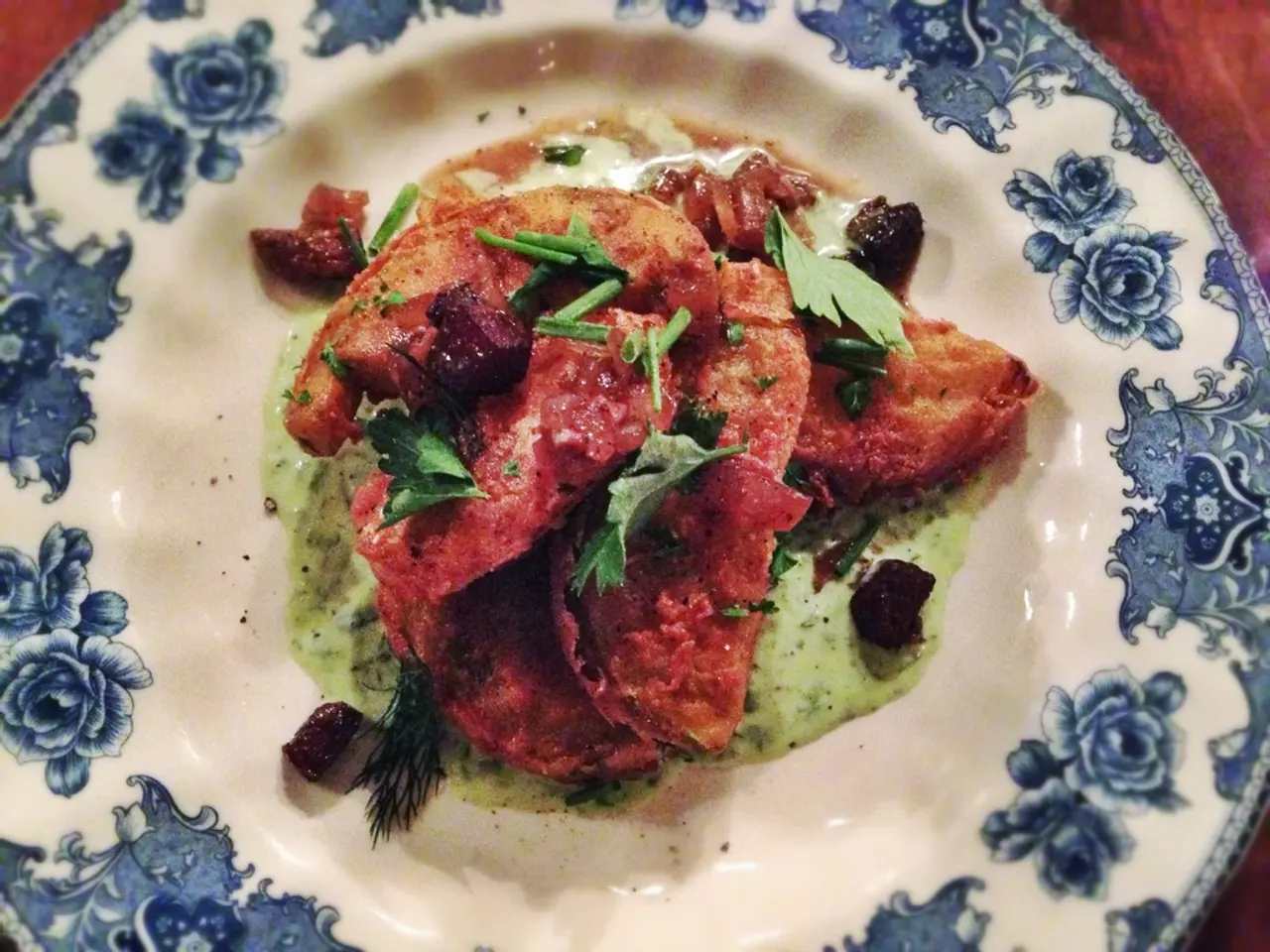 In this image there is a plate having some food in it. Plate is painted with some design having...