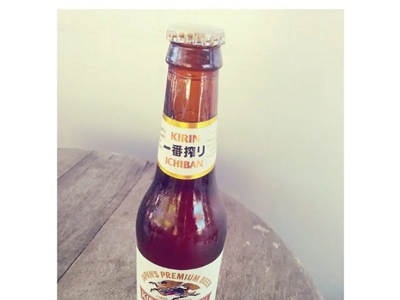 There is a bottle in image. In which it is labelled as kirin ichiban. which is placed on table and...