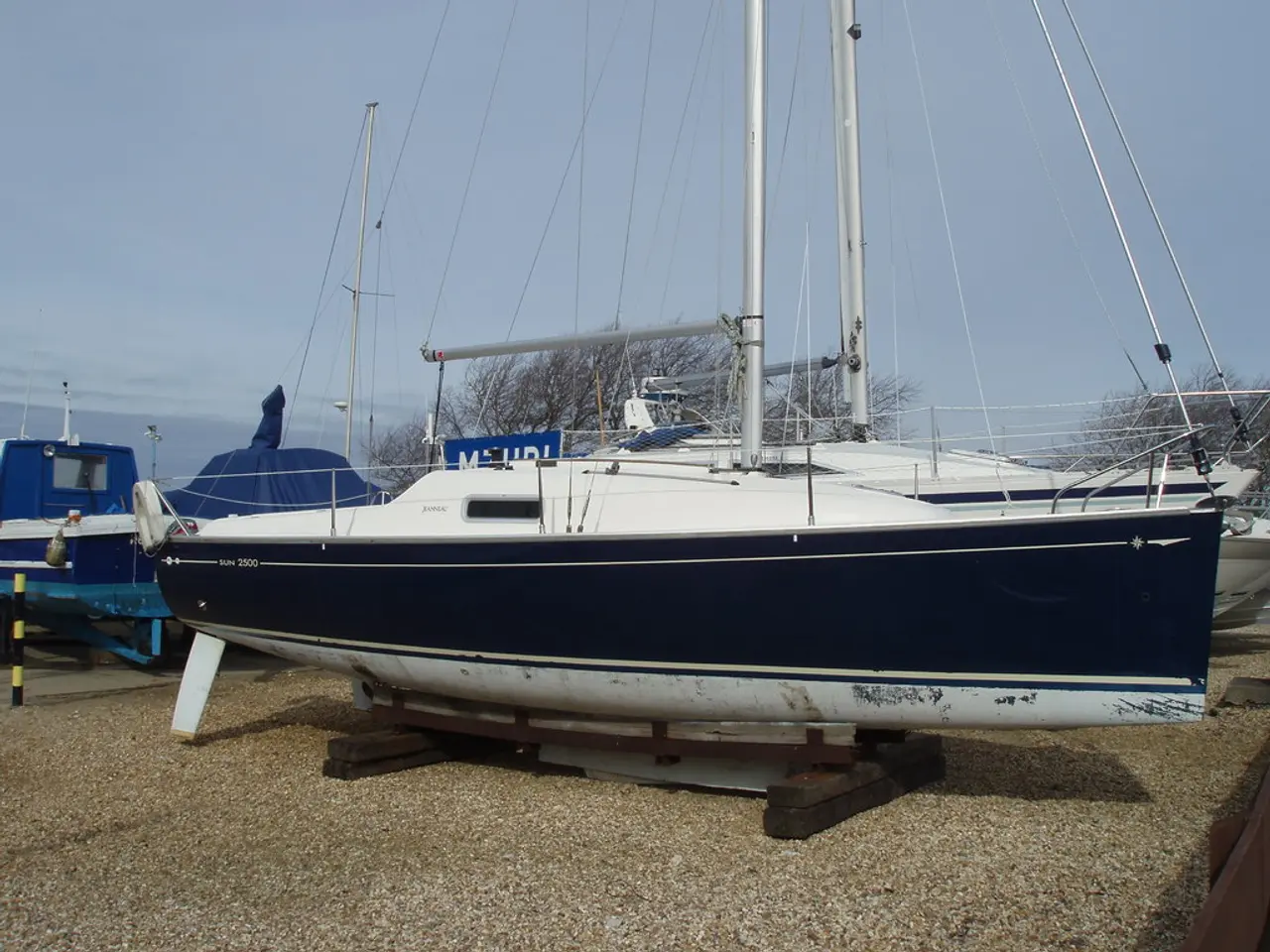 In this picture there is a sandbagger sloop in the center of the image.