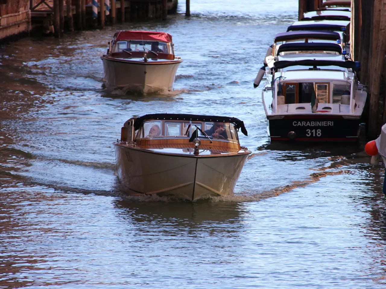 In this picture there are boats on the right side of the image and in the center of the image and...