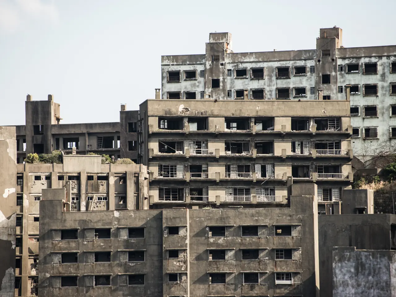 The picture consists of buildings and trees. Sky is sunny.