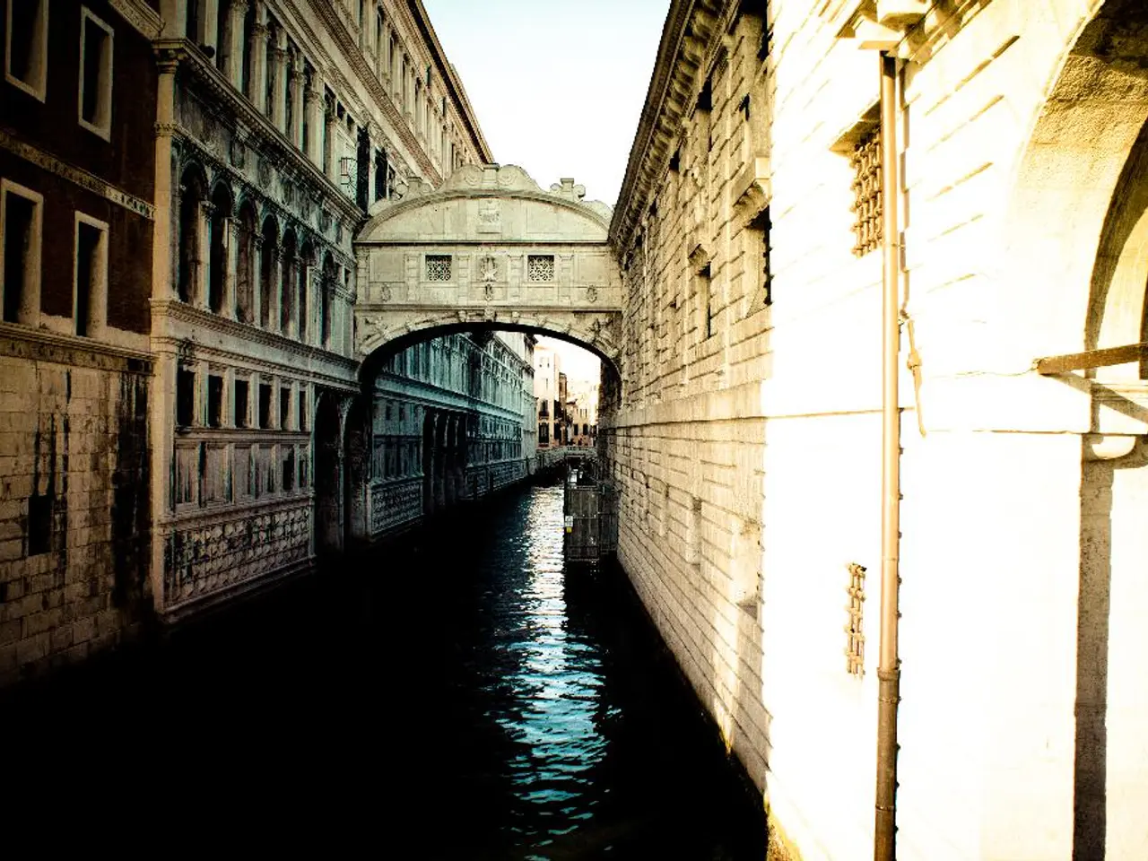 In this picture there is water and there are buildings on either sides of it.