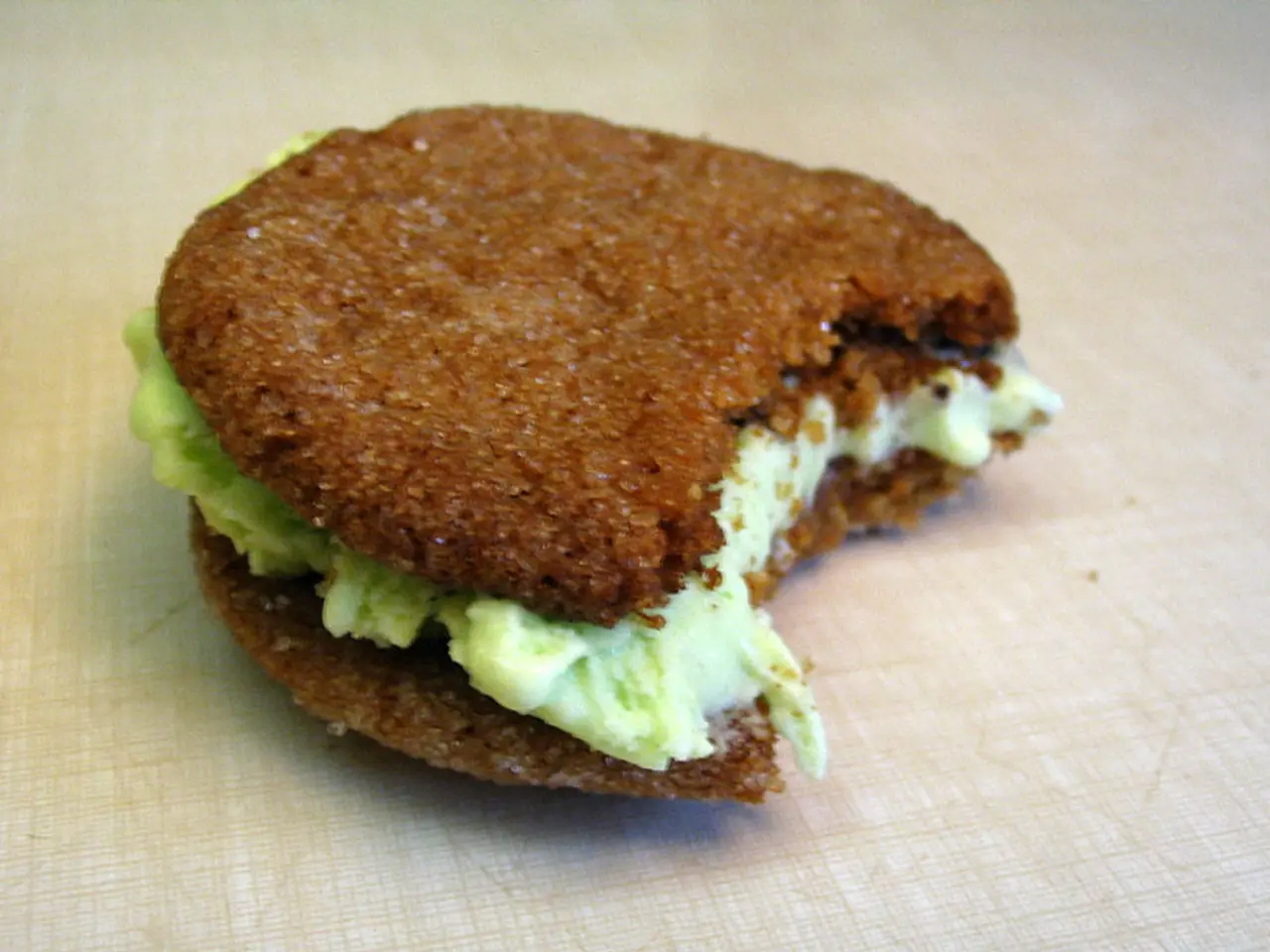 In this image there is a burger on the white color surface.