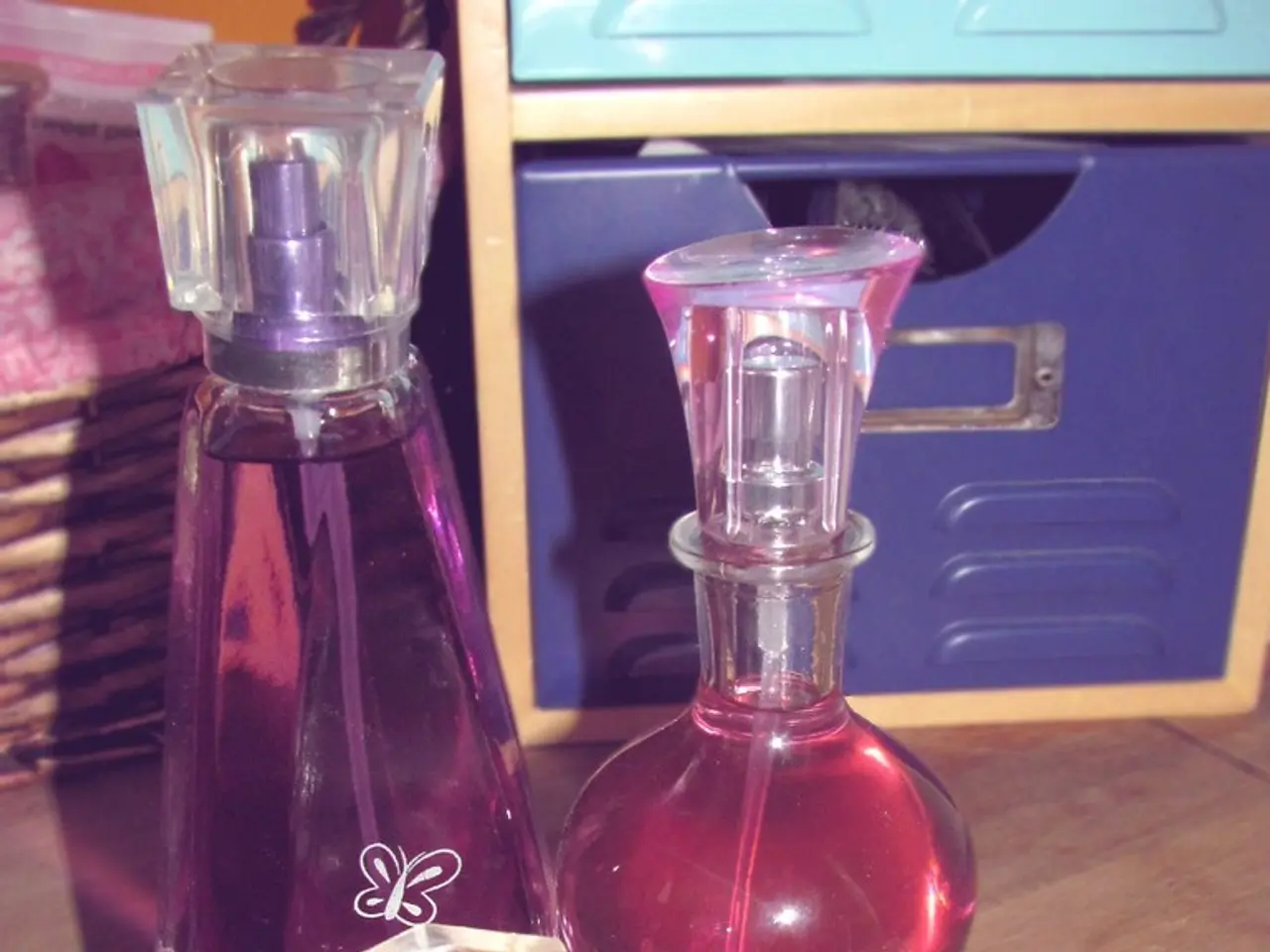 In this image I can see few perfumes and a box.