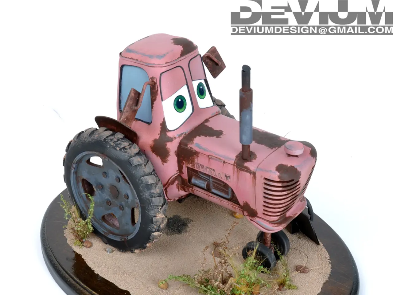 In this picture I can see the brown color surface on which there is sand and few plants and I see a...