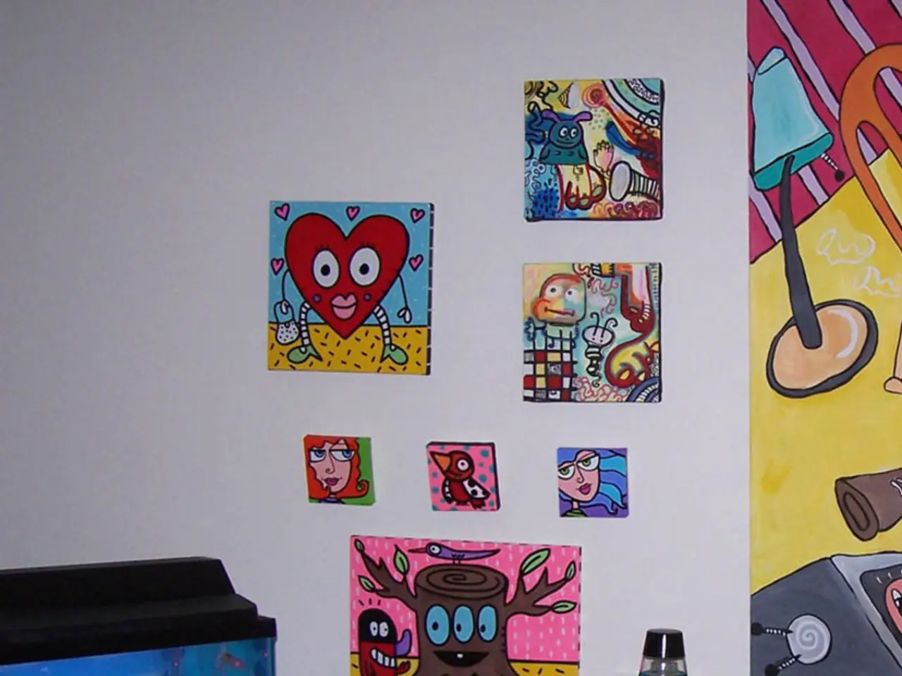 In this image there is a fish aquarium on the wooden surface. There are two bottles placed on the...