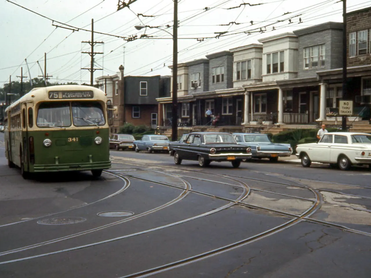 In this image in the center there are some vehicles, and on the left side there is one bus. At the...