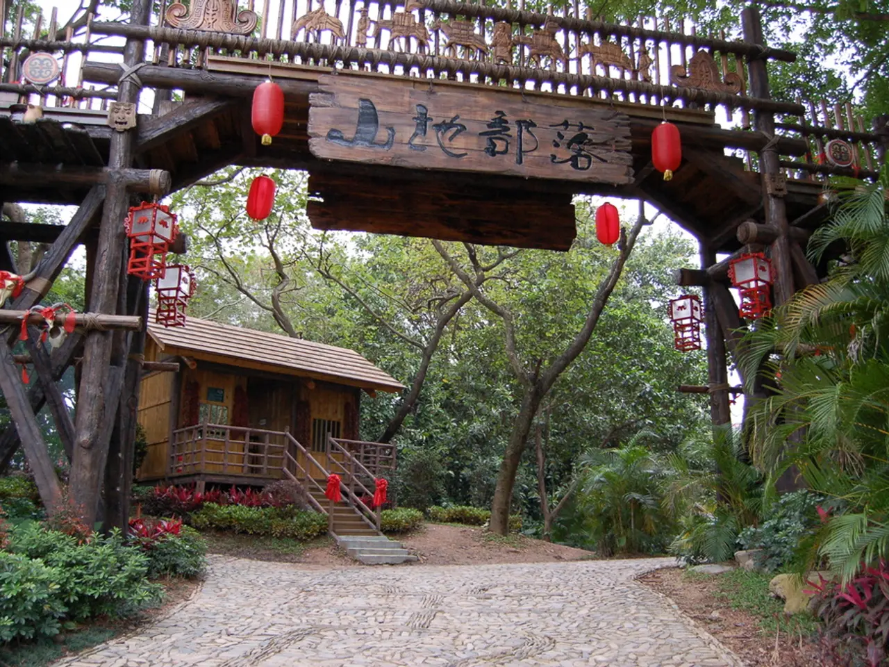 In the image there is a wooden house and around the house there is a lot of greenery. In front of...