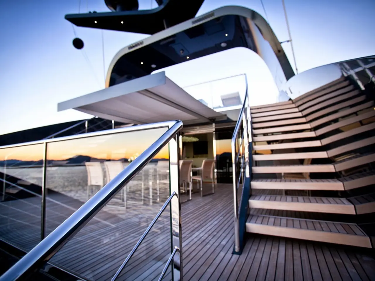 In this image there is a glass building. On the right side there are steps. On the left side there...