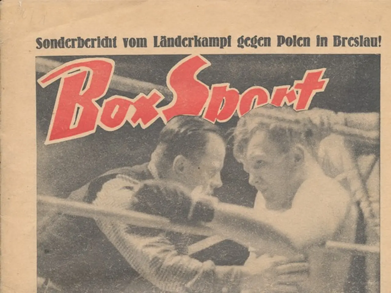 The image shows an old newspaper with a picture of two boxers in a boxing ring, with the words "Box...