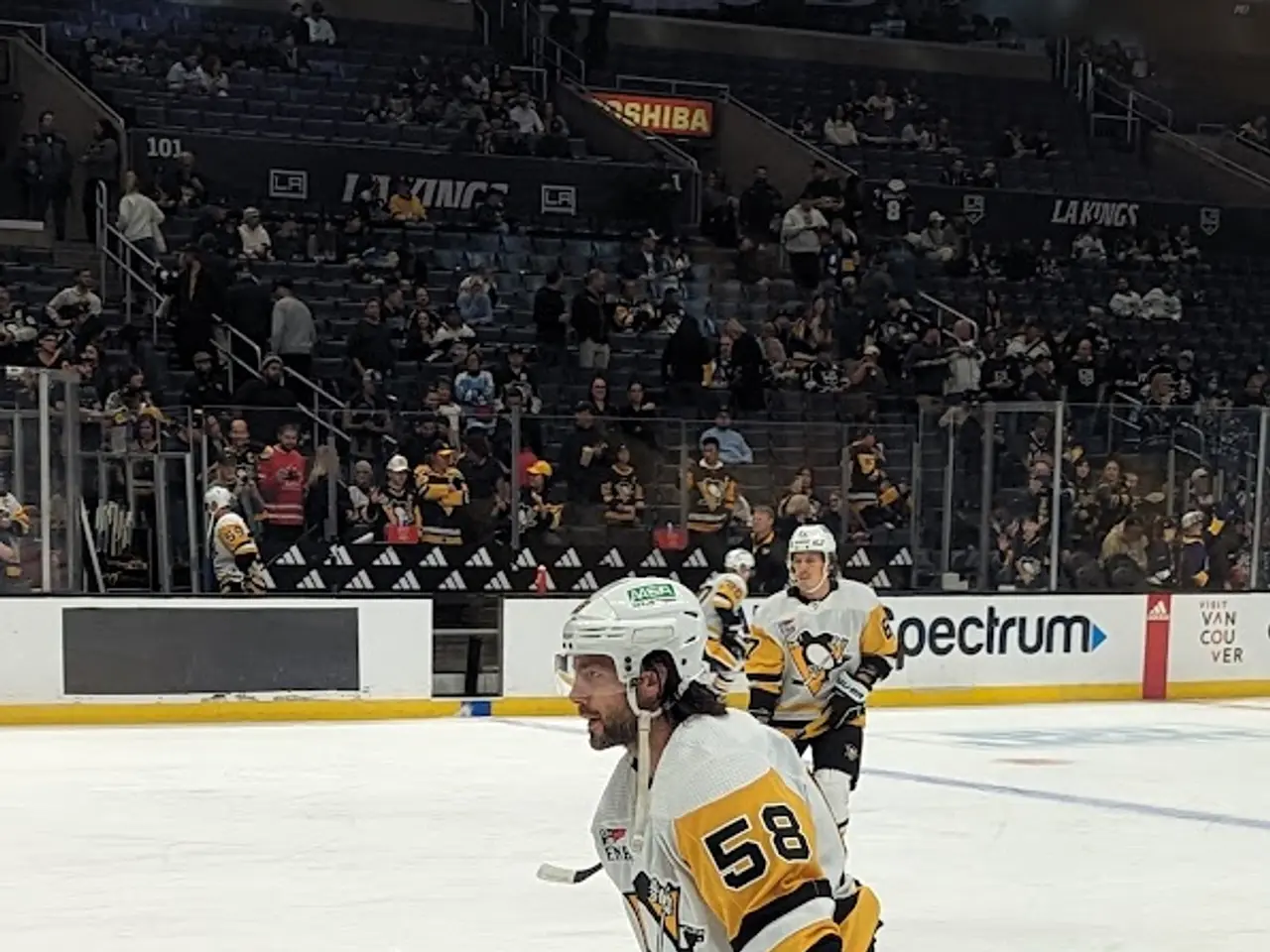 The image shows a hockey player on the ice with a stick in hand, wearing a helmet, gloves, and...