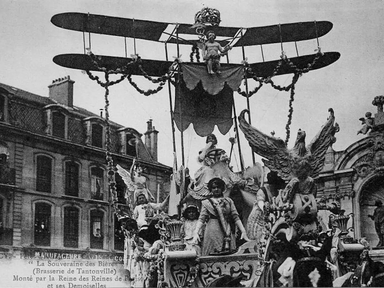 The image shows an old black and white photo of a float in a parade, with a group of people...