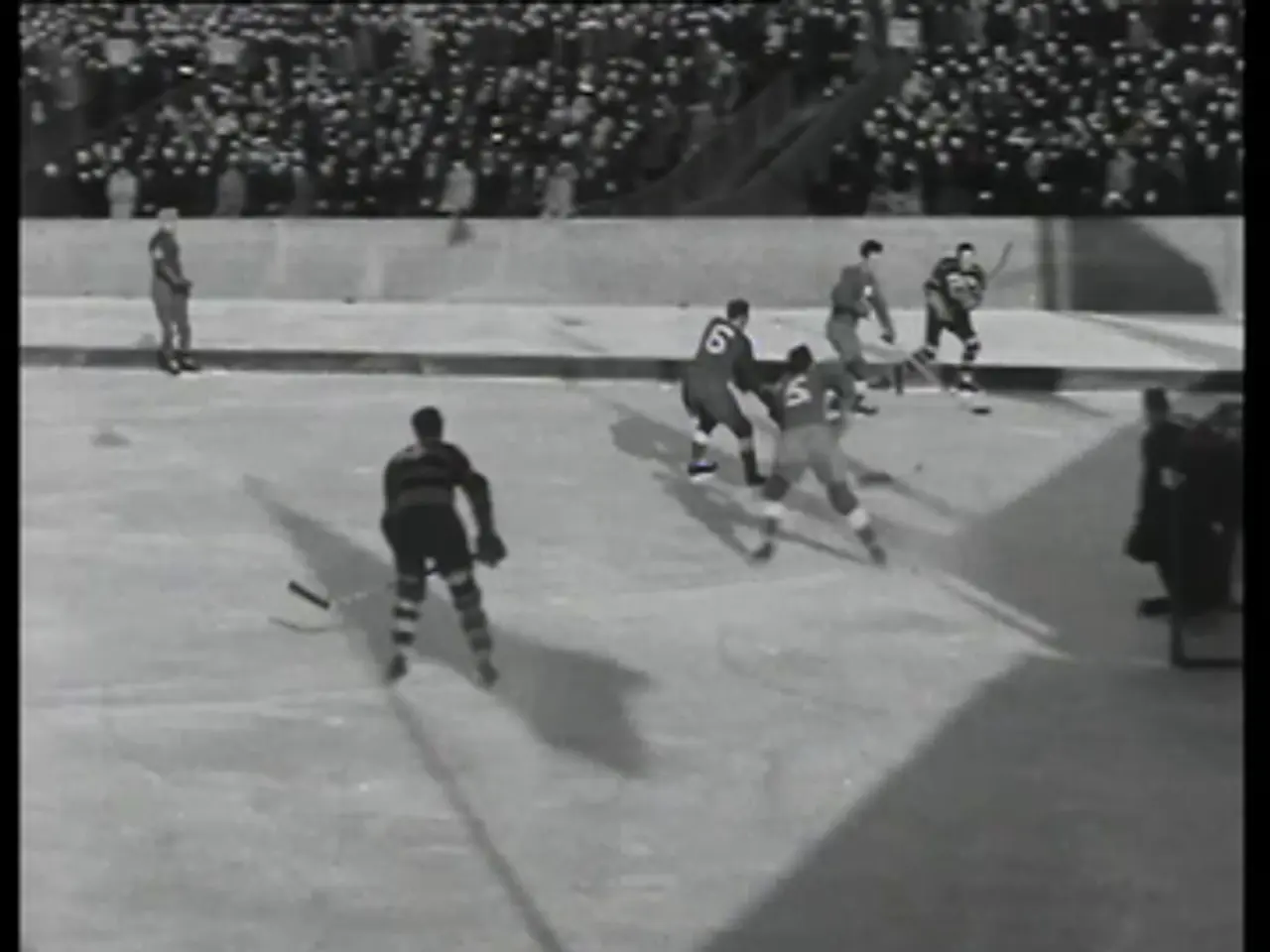 The image shows a group of men playing a game of hockey on an ice rink, with a crowd of spectators...