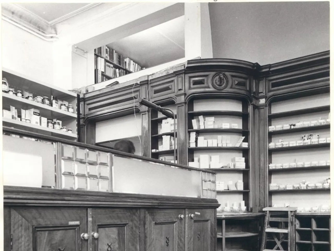 The image shows a black and white photo of a pharmacy with a counter, cupboards, a ladder, and...
