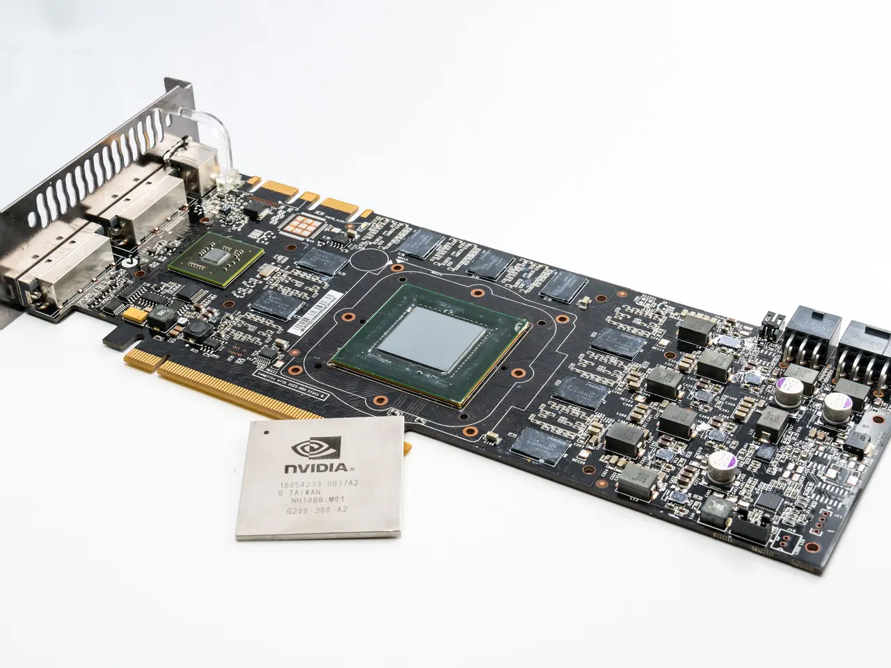 The image shows a close up of a motherboard with a chip on top of it, sitting on a white surface....