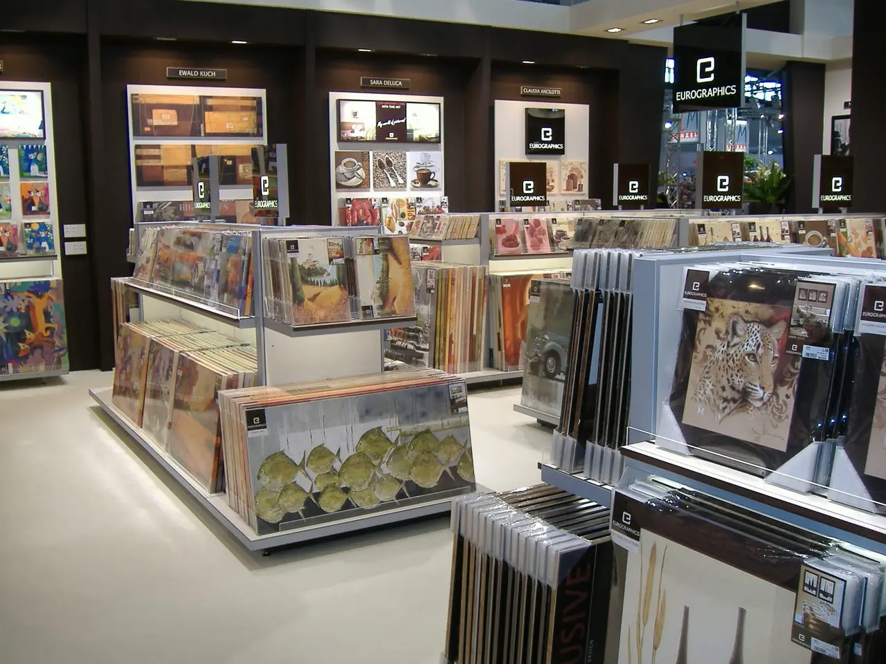 The image shows a store filled with lots of different types of CDs, arranged in racks and on the...