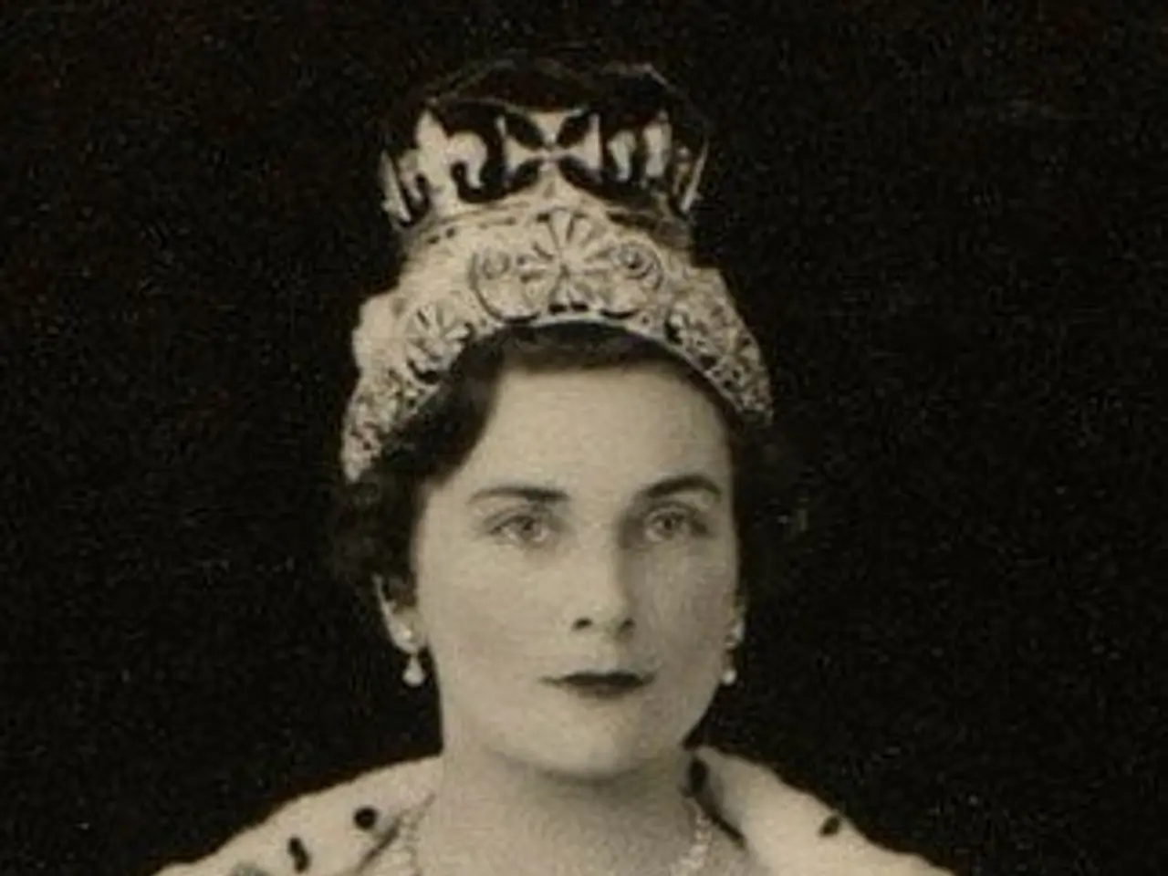 The image shows a black and white photo of Queen Elizabeth II wearing a crown, with a dark...