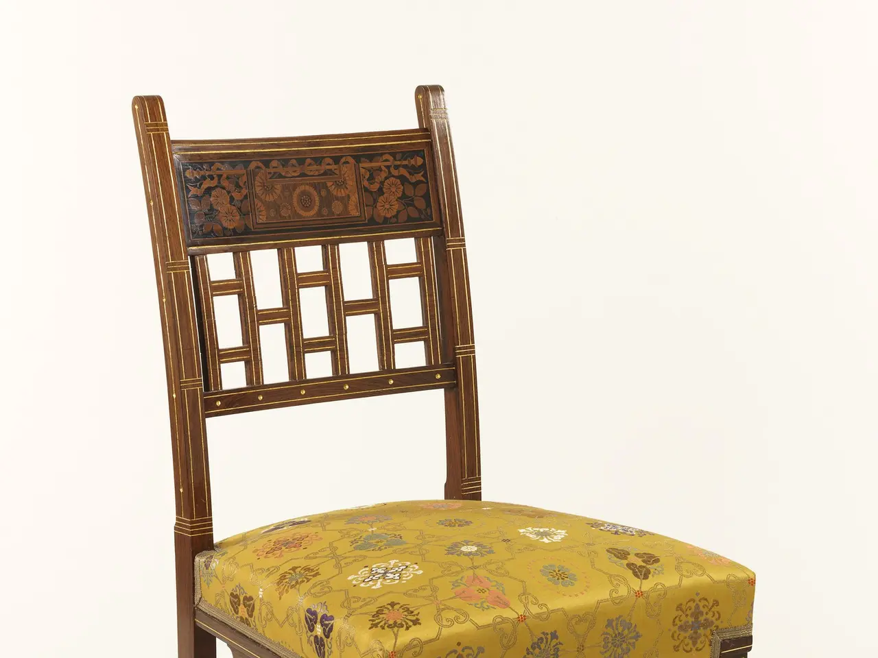 The image shows a wooden chair with a yellow upholstered seat against a white background. The chair...
