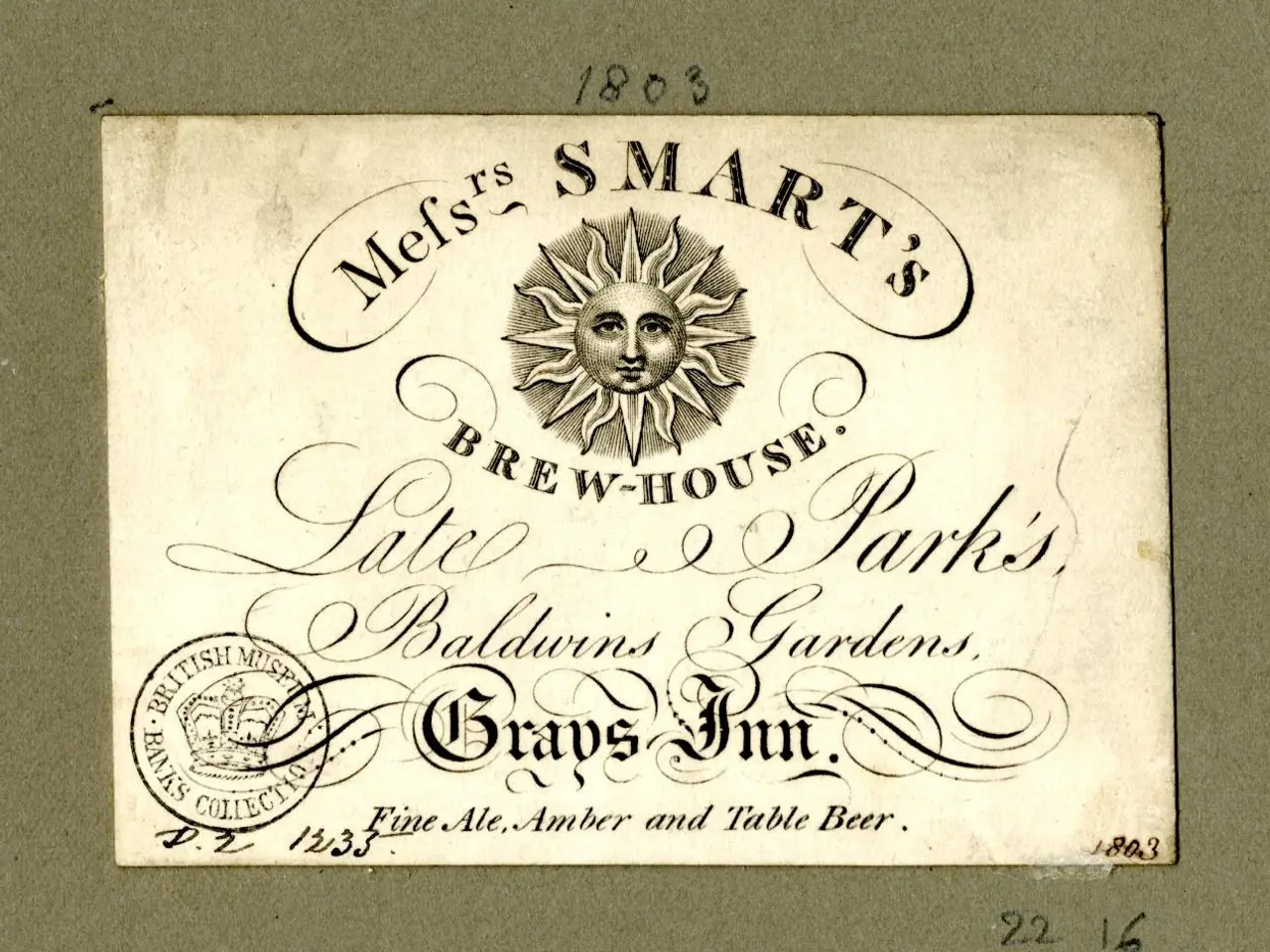 The image shows an old business card with a sun on it. The card has text written on it, as well as...