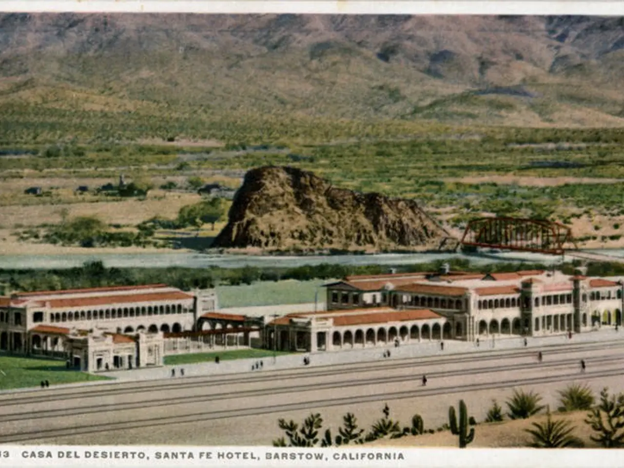 The image shows an old postcard of the Casa del Desierto, Santa Fe Hotel in Barstow, California. It...