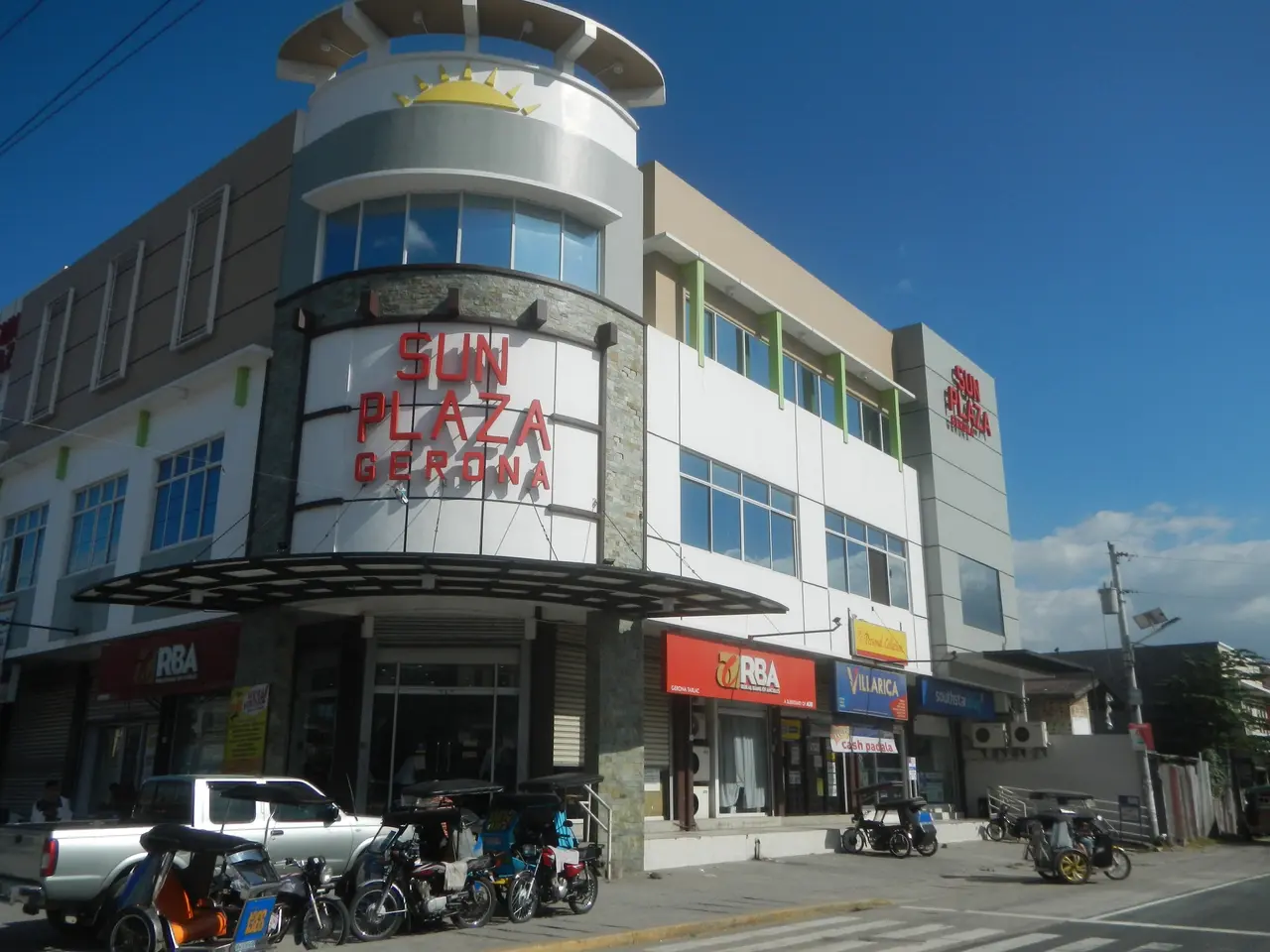 The image shows the Sun Plaza Gerona in Cebu City, Philippines. It features buildings, motor...