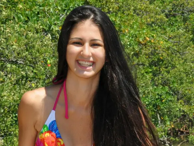 Model Maya Jama demonstrates her stunning physique in a deeply plunging swimsuit, basking in the...