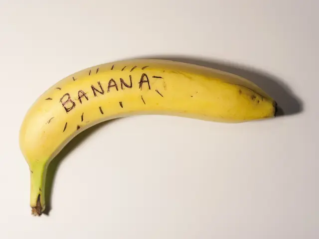 In this image I can see the banana on the white color surface and the banana is in yellow color.