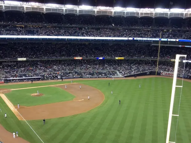 In this picture I can see it looks like a stadium, at the bottom there is the ground, few people...