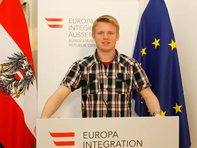 At the bottom of the image there is a podium with mic. Behind the podium there is a boy standing....