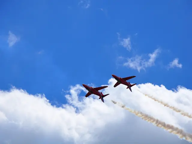 In this picture we can see two planes are in the air and we can see clouded sky.