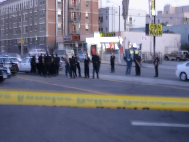 In this picture we can see a crowd of people standing on the road and cars and here it is a ribbon...