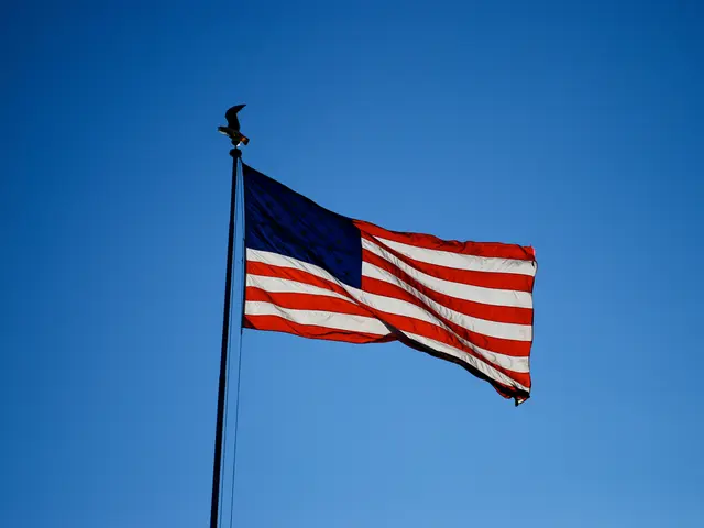 In this image we can see flag of united states and at the background of the image there is clear...