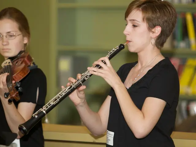 In this picture we can see a spectacle, two women holding clarinet, violin with their hands and in...