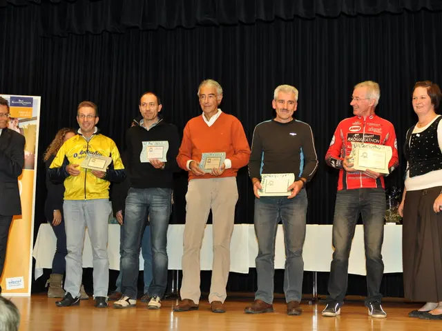 In this image we can see a group of people are standing on the stage and holding certificates in...