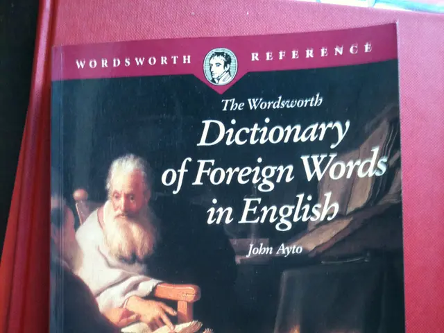 In this image there are books. There are pictures of two people and there is text on the book.