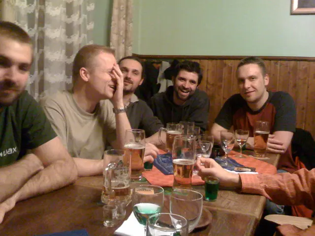 There is a group of people. They all are sitting in a room. They all are laughing. There is a...