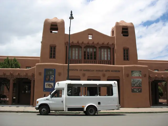 In this picture there is a white truck which is parked near to the street light. In the back there...