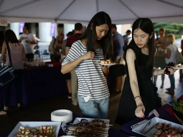At the top of the image I can see the tent. Here I can see two women standing and holding the...