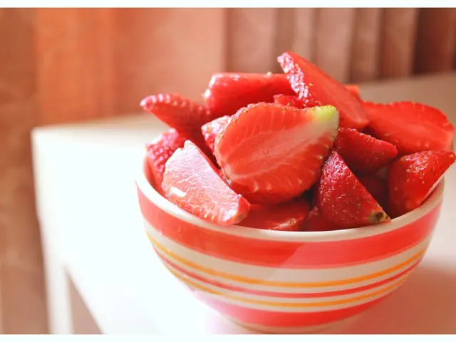 As we can see in the image there is a table. On table there is a bowl. In bowl there are strawberry...