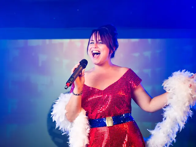 A woman is standing and singing on the microphone.