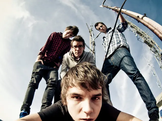 In this picture we can see a boy lying on the ground and looking at the camera. Behind there are...