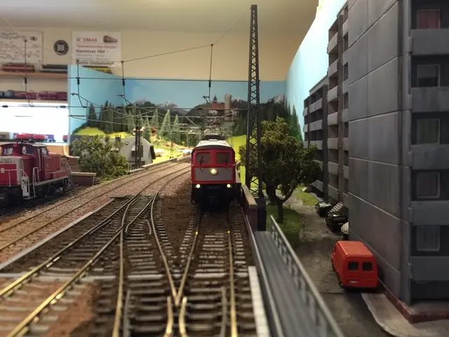 In the foreground of this image, there is a toy train and an engine on the track. We can also see...